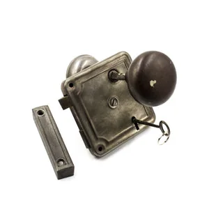 Antique steel rim lock with traditional doorknobs, key and matching strike