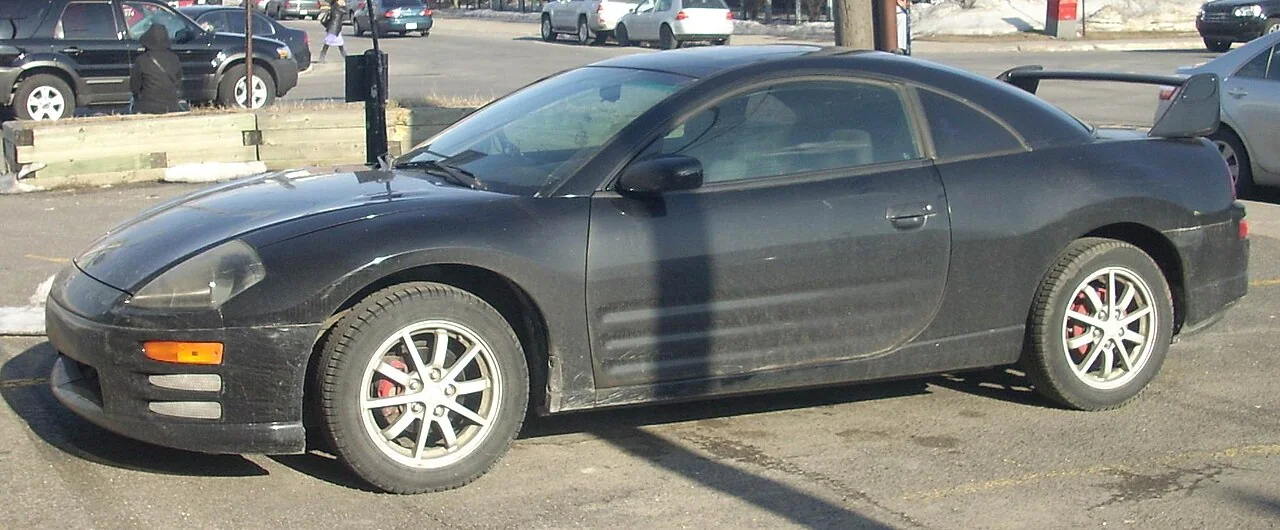 2000–2002 Mitsubishi Eclipse — representative vehicle generation; Canadian example with aftermarket wheels and rear wing